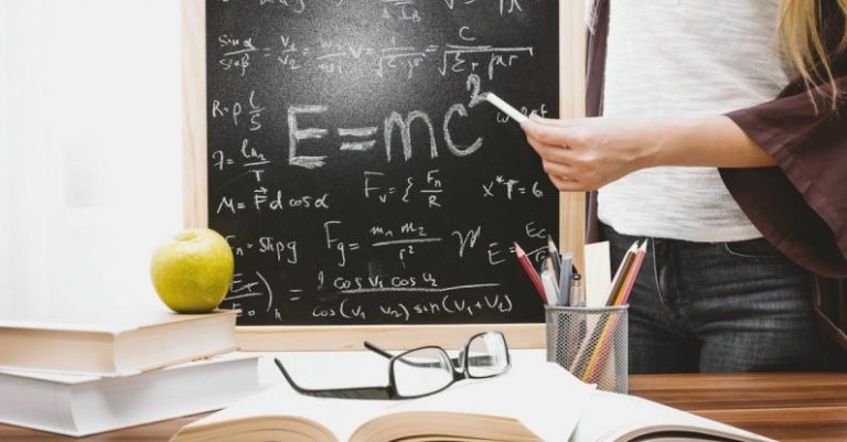 Lessons - Woman Illustrating Albert Einstein Formula